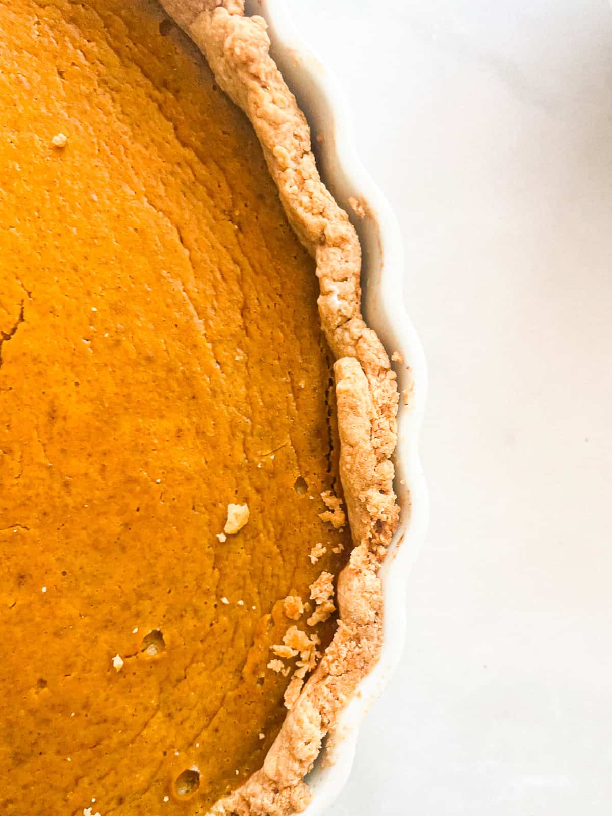 Crust and pumpkin pie in a pie plate.