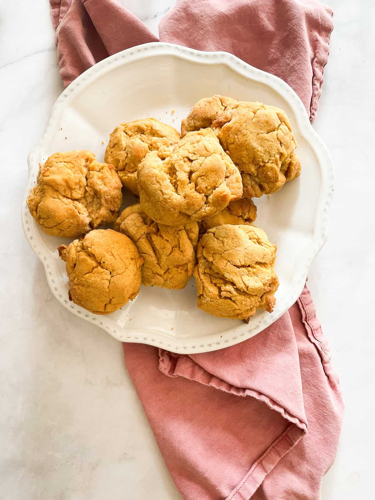 A plate of sweet potato biscuits on a red napkin.