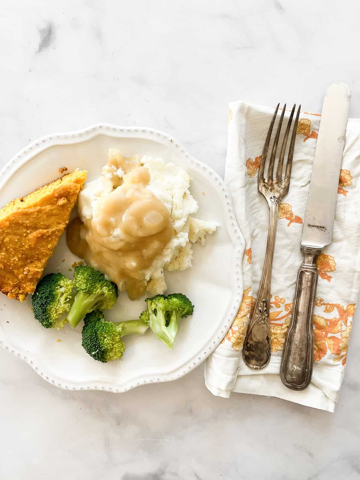 Vegan gravy on top of mashed potatoes on a plate.