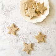 A plate of gluten free sugar cookies and cookies on a counter.