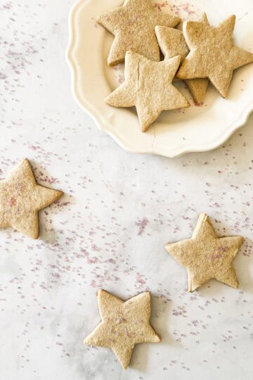 A plate of gluten free sugar cookies and cookies on a counter.