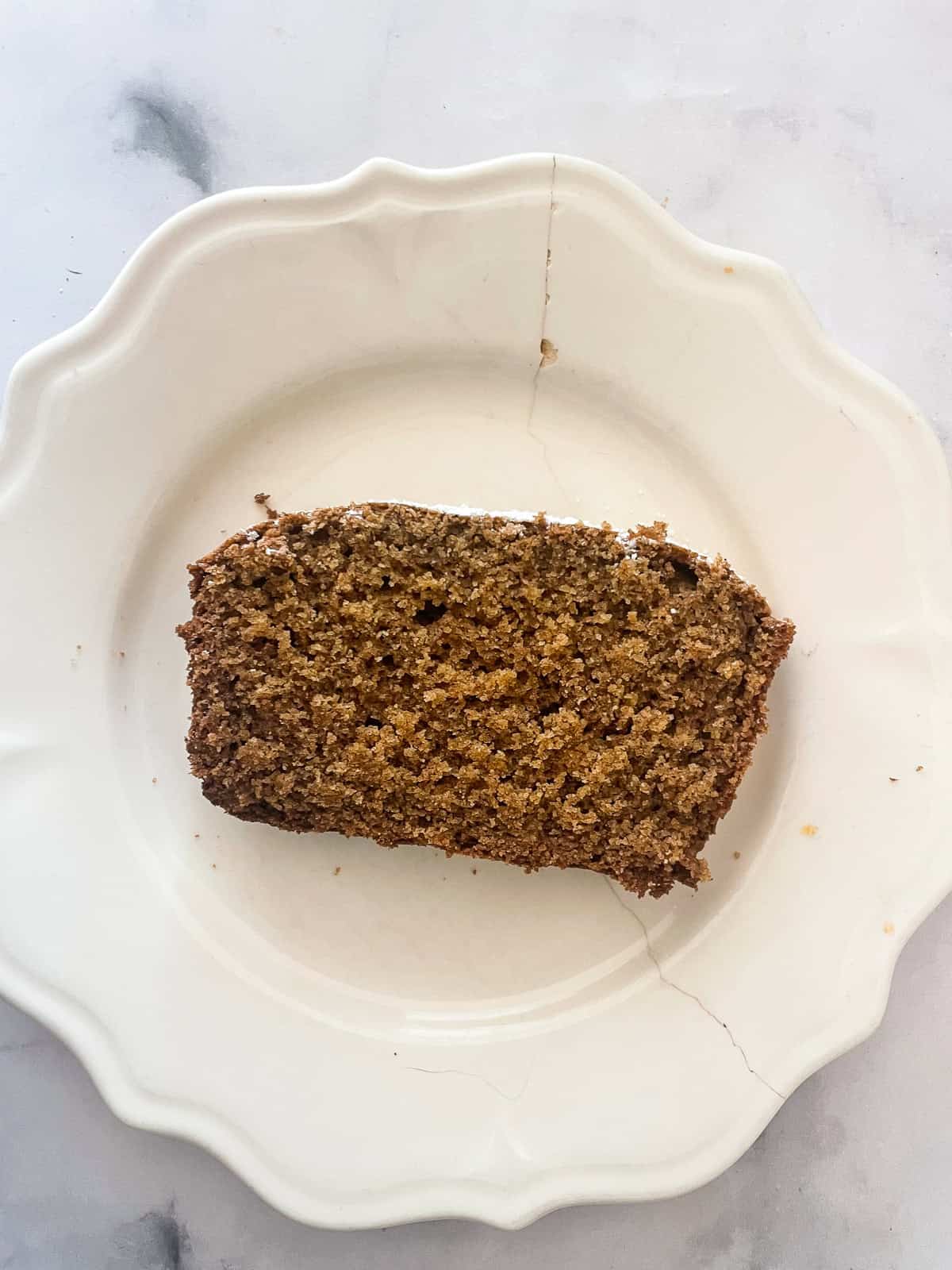 A slice of gingerbread loaf on a plate.