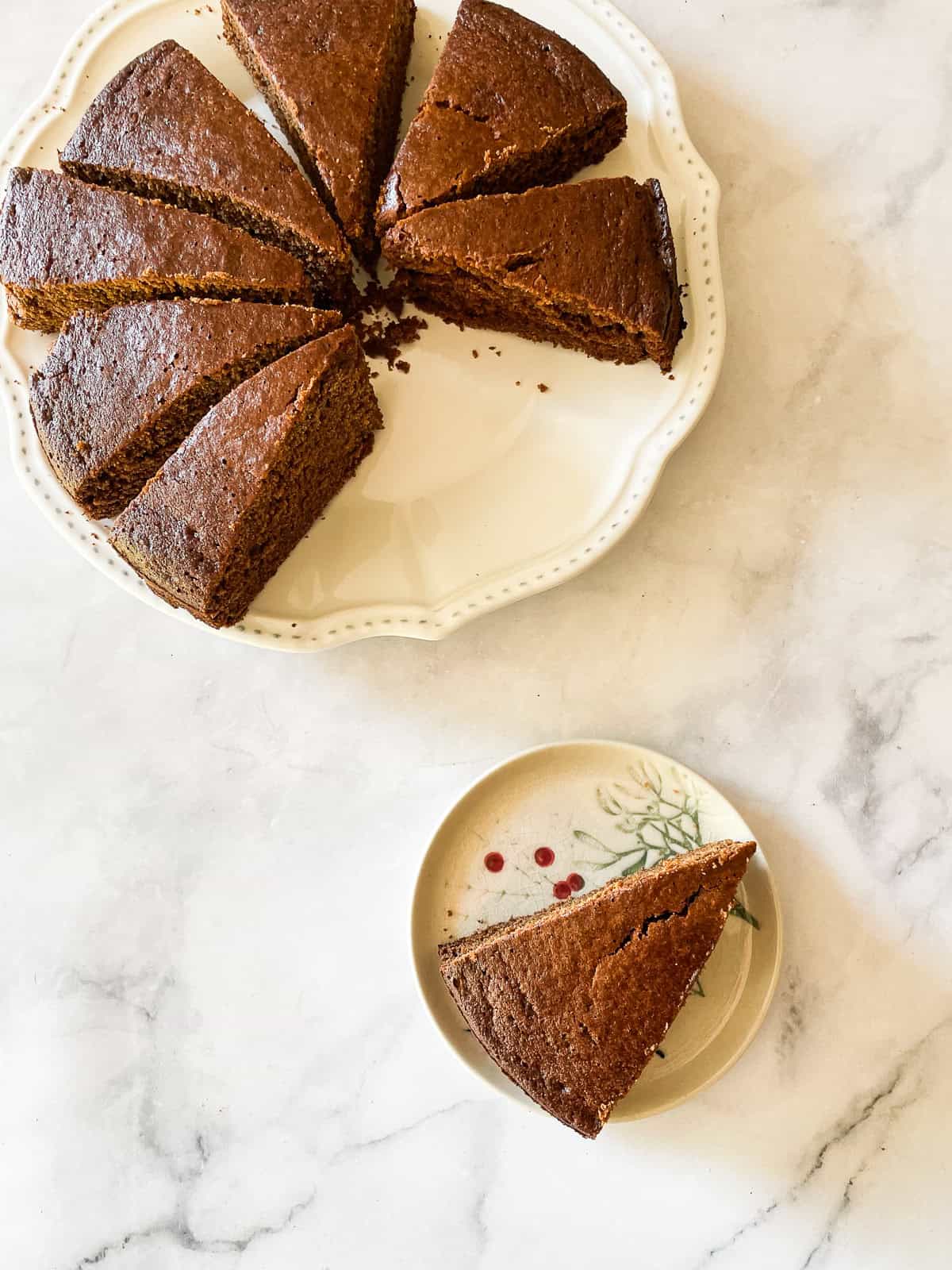 Slices of gluten-free gingerbread on a plate and a slice on a plate.