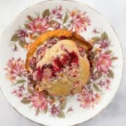 A gluten free orange cranberry muffin on a plate.