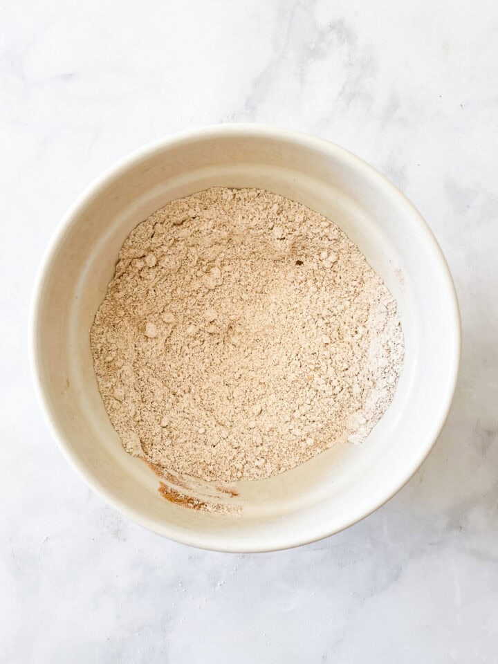 Flour and spices whisked together in a bowl.