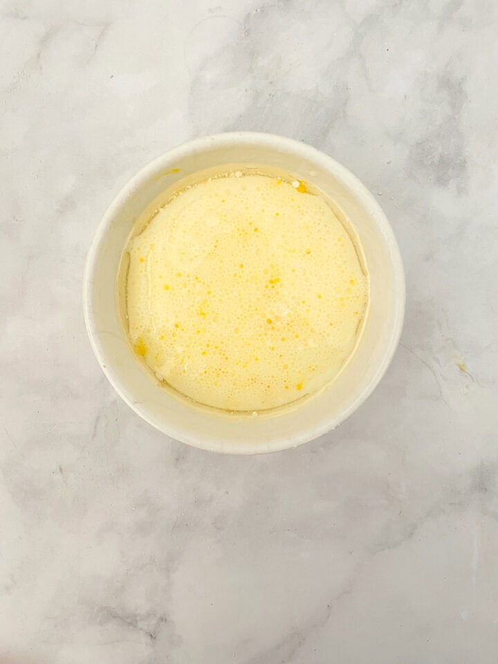 Egg and milk whisked in a bowl.