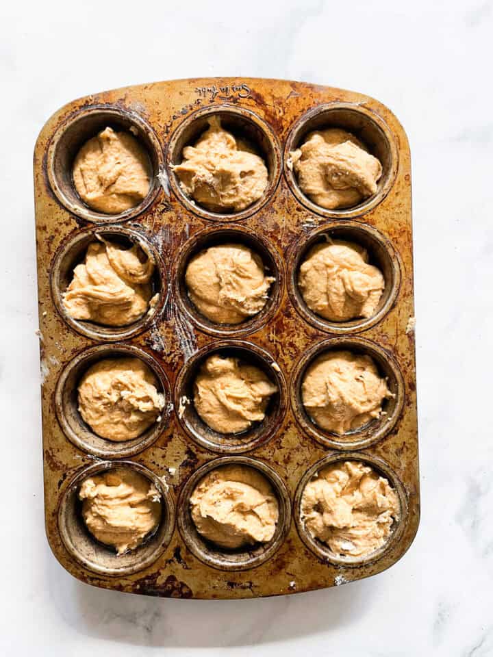 Batter for gluten free persimmon muffins in a muffin tin.