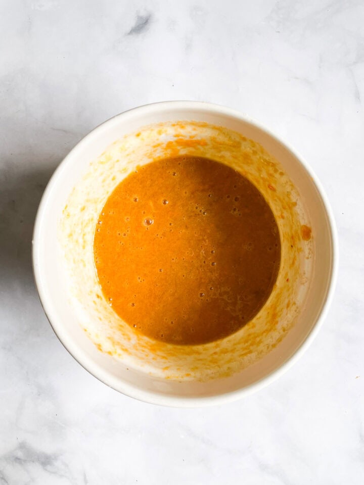 Wet mix for persimmon muffins in a bowl.