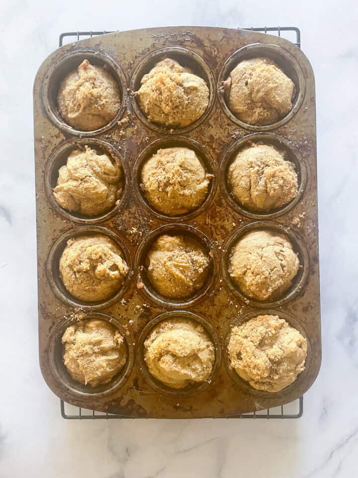 Gluten free persimmon muffins cool in a tin.