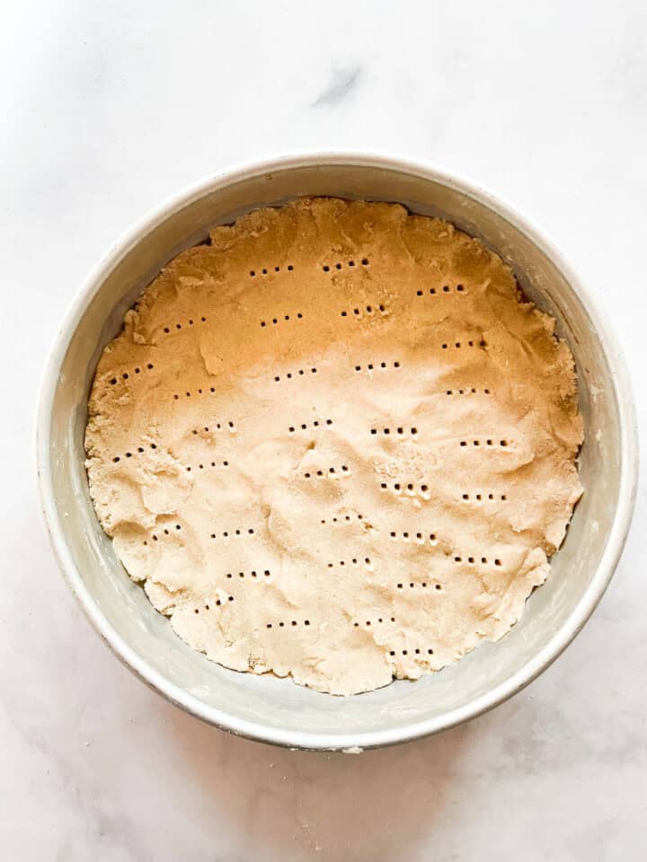 Shortbread dough pricked all over with a fork.