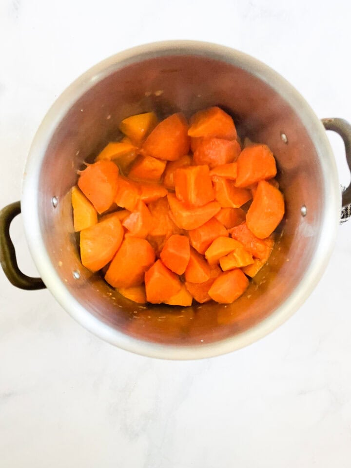 Persimmons in water in a pot.