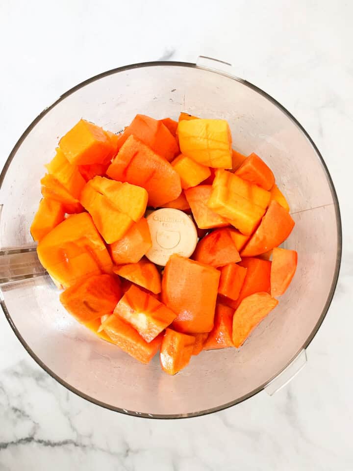 Persimmon pieces in a food processor.