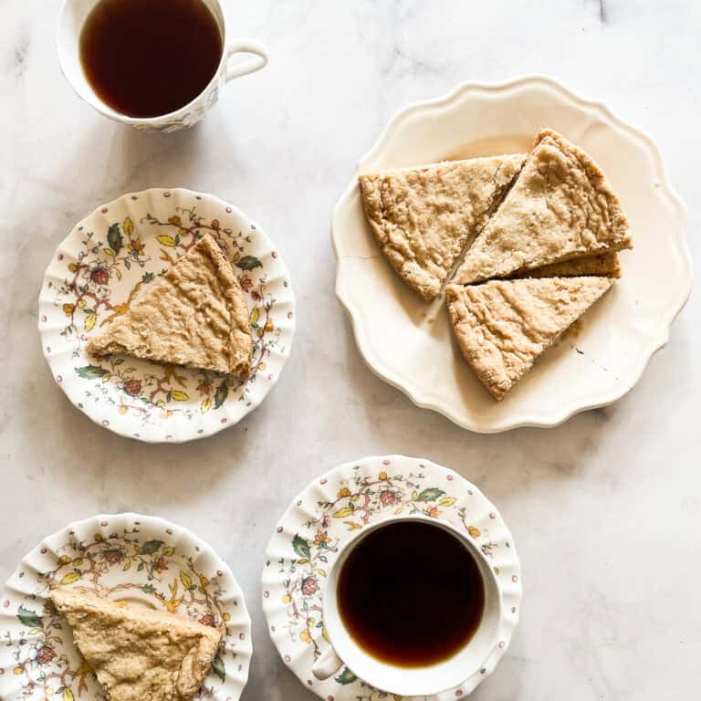 Plates of oat flour shortbread along with cups of tea.