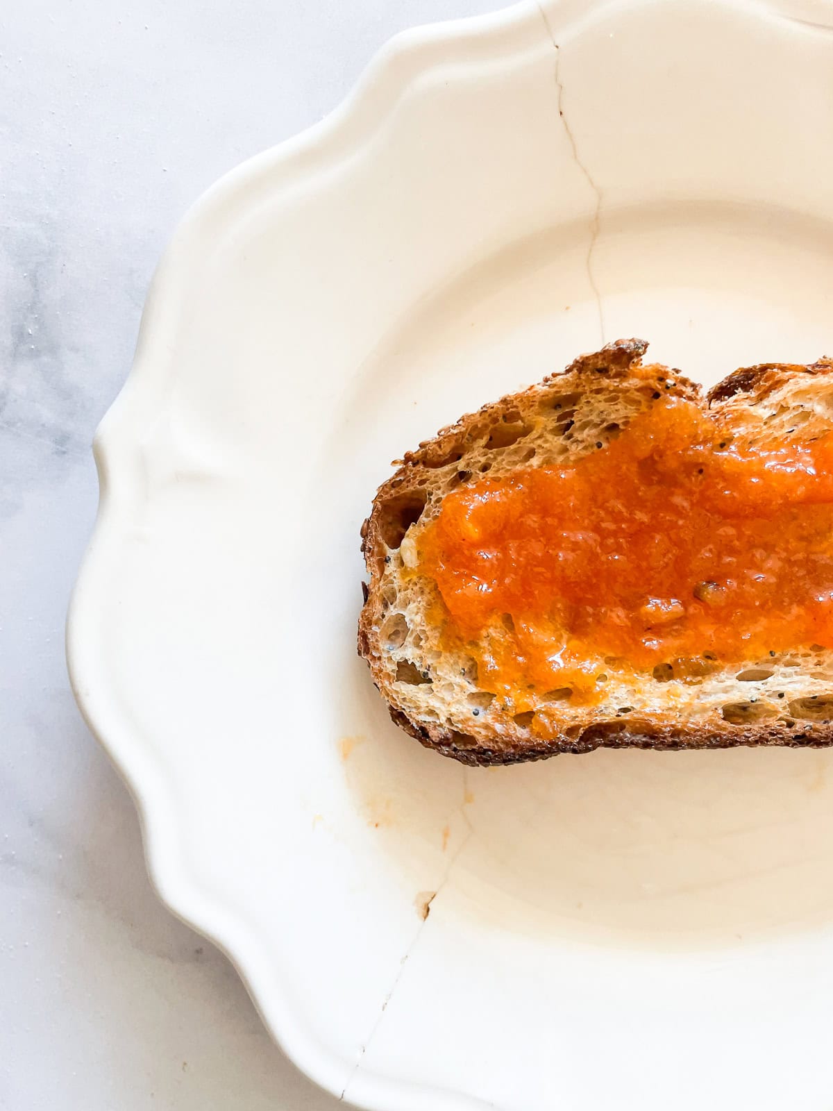 A slice of toast topped with persimmon jam.