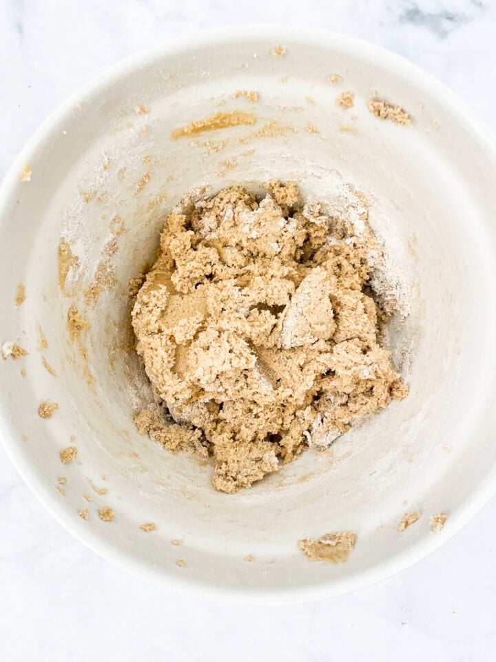 Dry mix added to wet mix in a bowl for cookie dough.