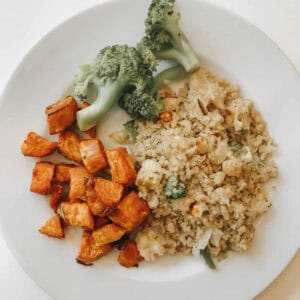 A plate of coconut quinoa, sweet potatoes, and broccoli.