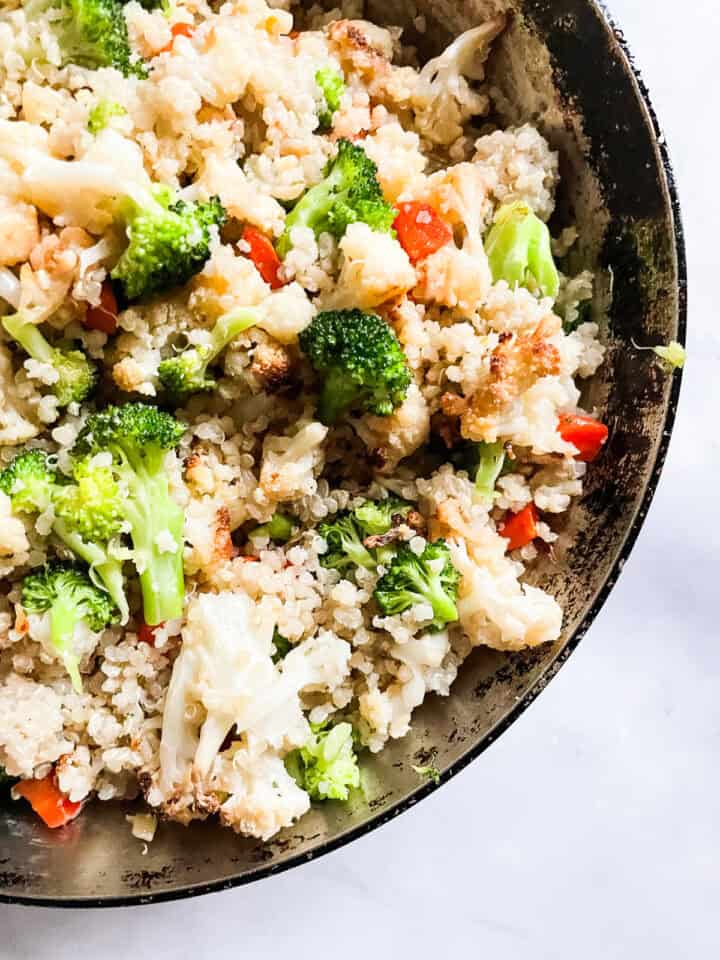 Broccoli in a skillet of coconut quinoa.