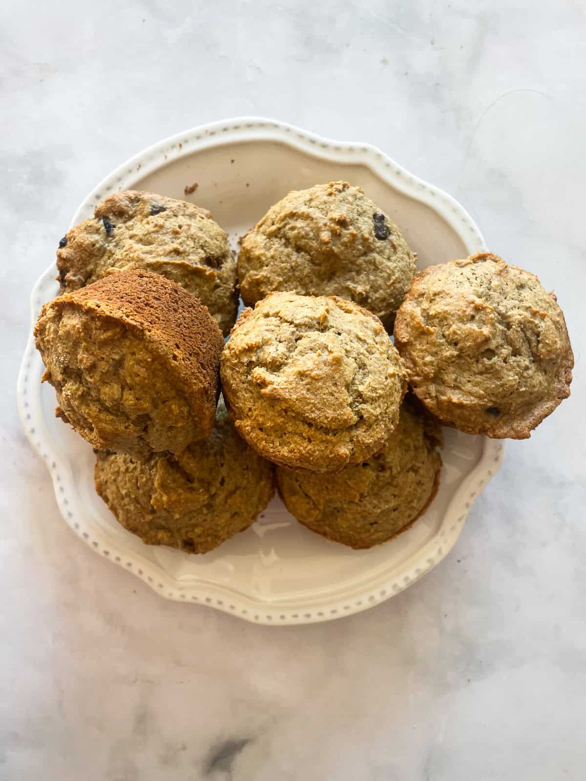 A white plate of gluten free banana bread muffins.