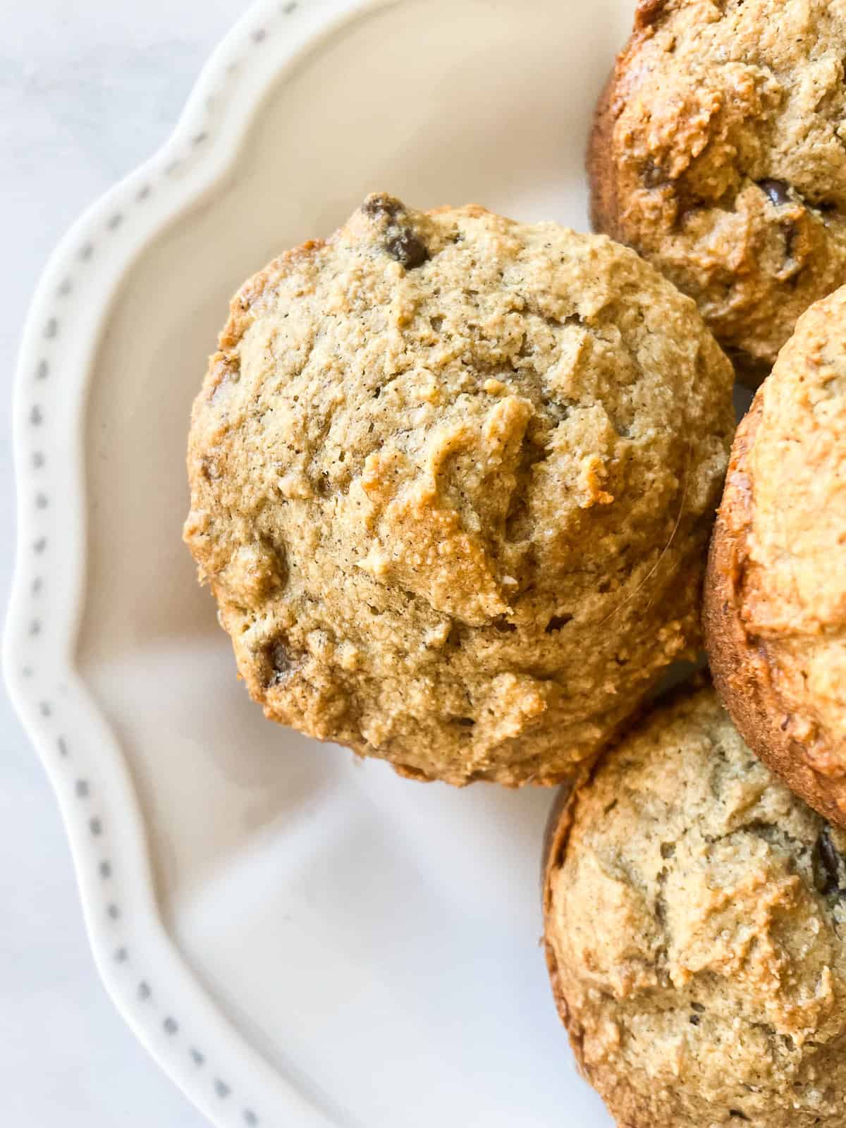 One banana bread muffin with more next to it.