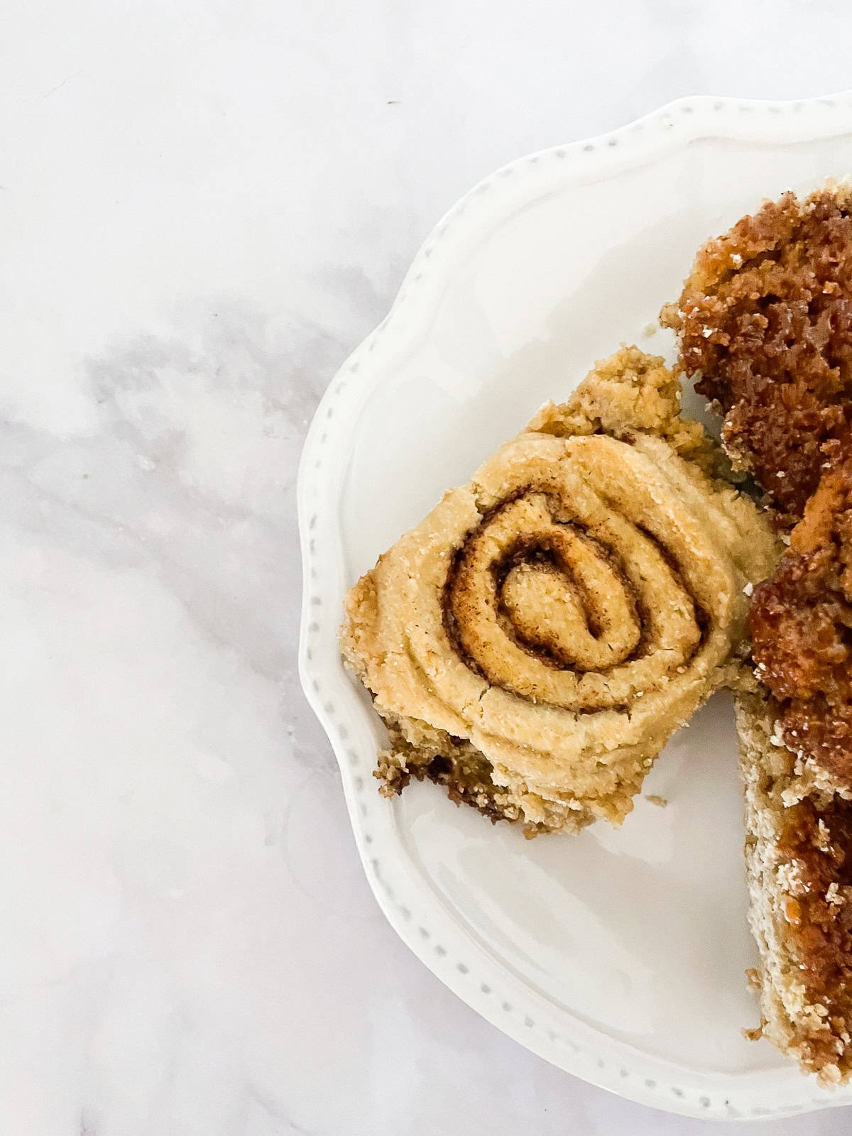 A spiral cinnamon roll on a plate.