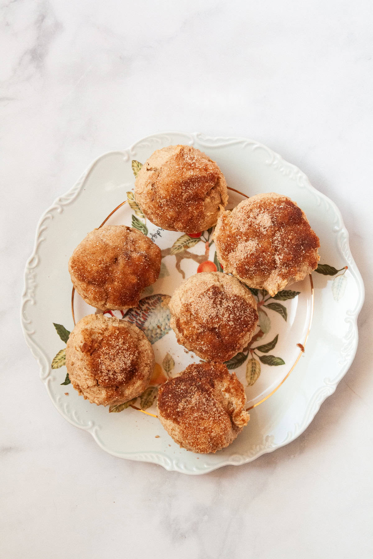 Gluten free cinnamon sugar muffins on a serving plate.