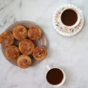 Cups of tea and gluten free donut muffins.