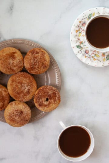 Cups of tea and gluten free donut muffins.