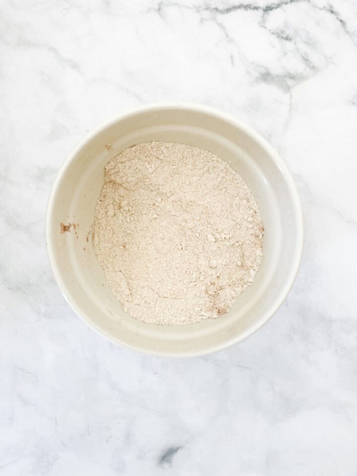 The dry ingredient mix for banana blackberry muffins in a bowl.