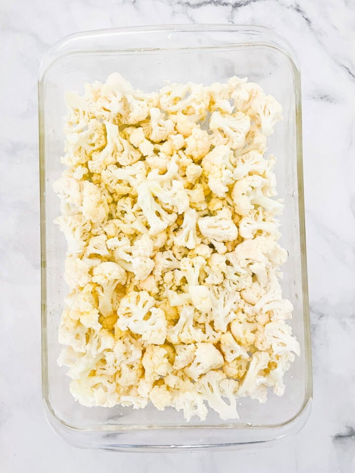 Break up cauliflower florets and put them in a pan.