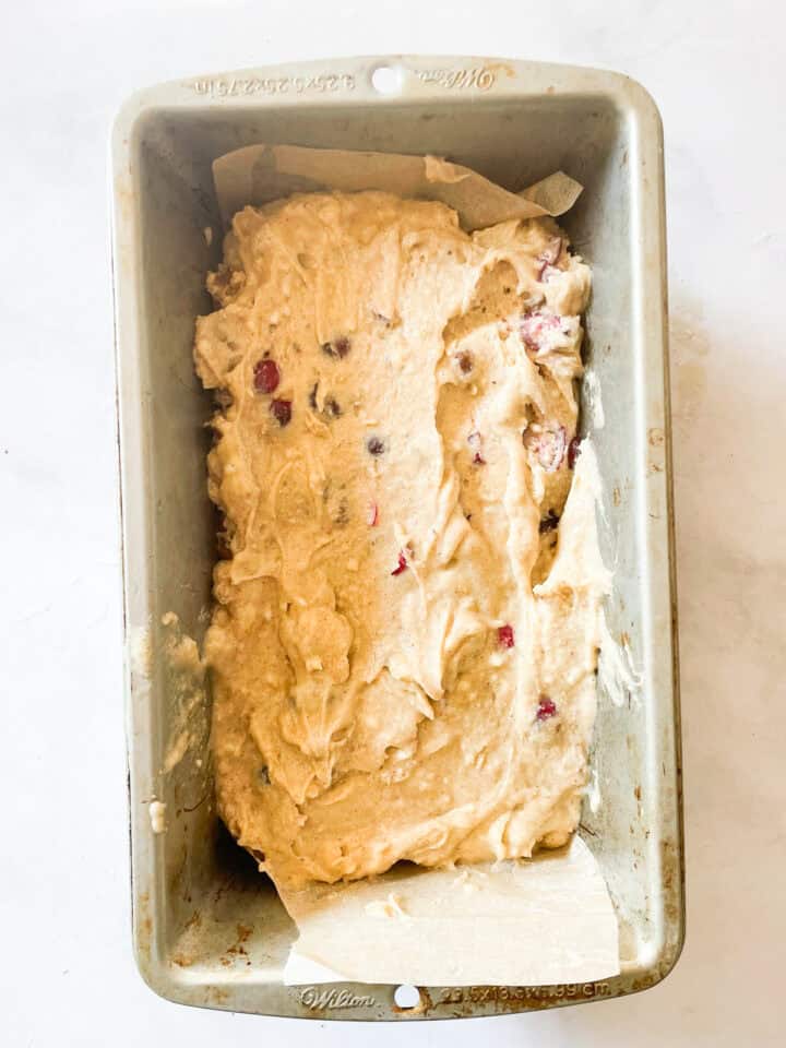 Cranberry walnut bread batter in a loaf pan.