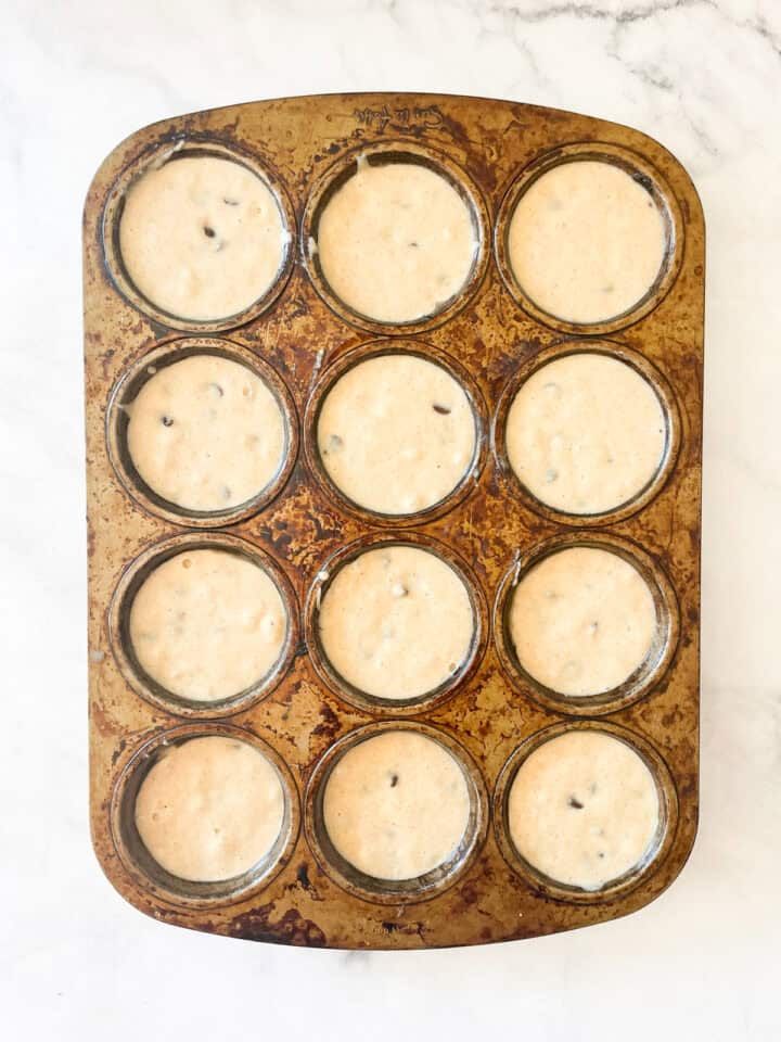 Gluten free chocolate chip muffins batter in a tin.