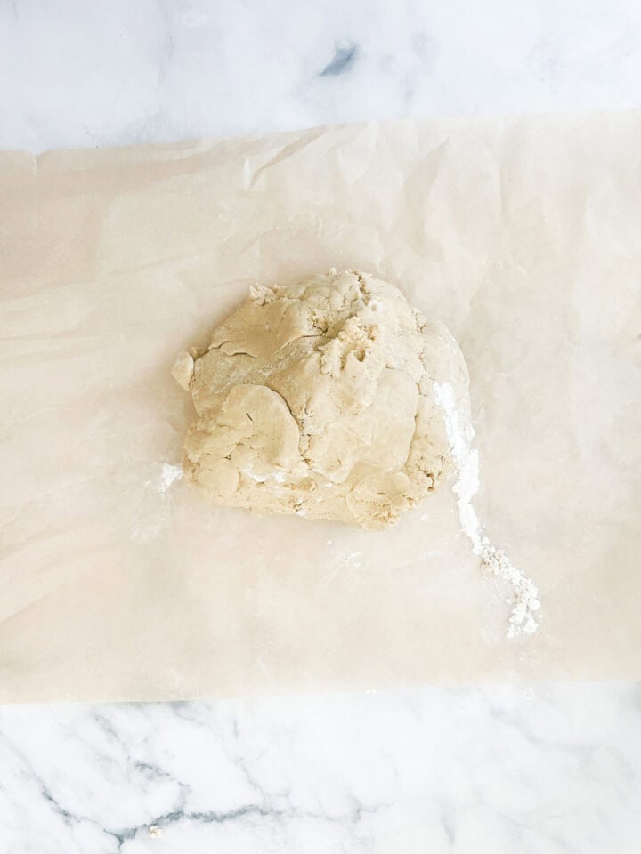 A ball of dough on a piece of parchment.