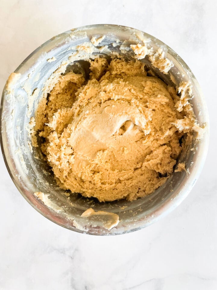 Dough in a metal bowl.