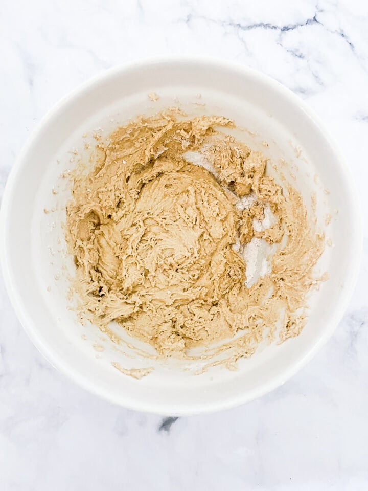 Cinnamon rolls dough combined in a bowl.