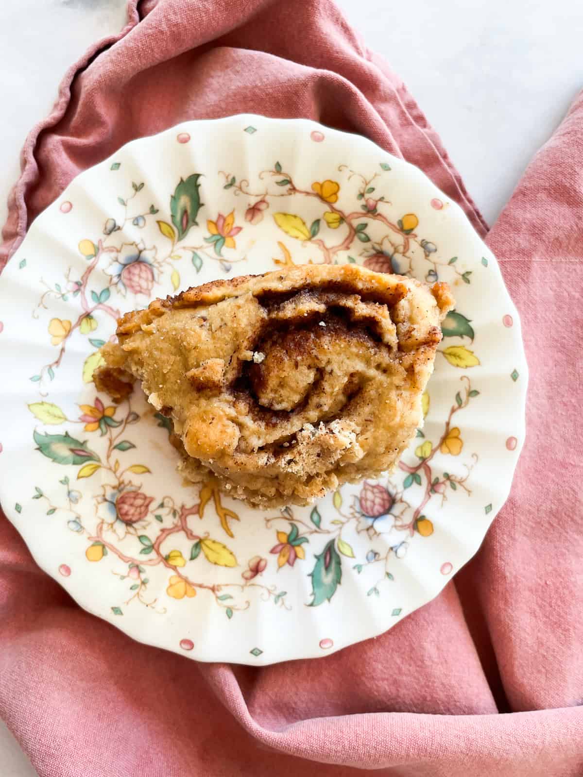 An oat flour cinnamon roll on a plate.