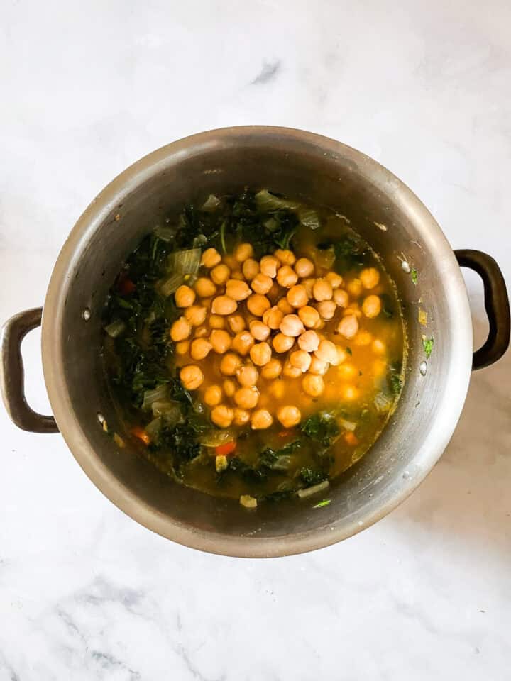 Chickpeas added to a pot of minestrone.