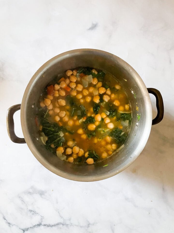 The kale wilts in the minestrone soup.