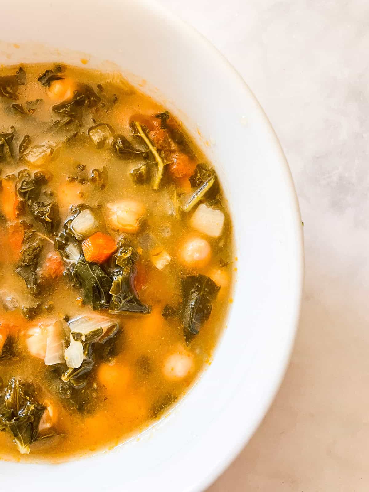 Kale and chickpeas in a bowl of minestrone soup.