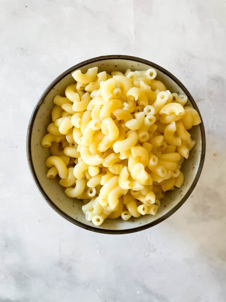 A bowl of cooked macaroni pasta.