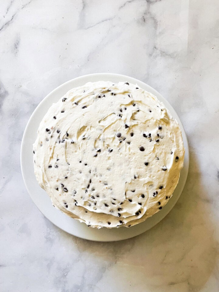 A frosted chocolate chip layer cake.