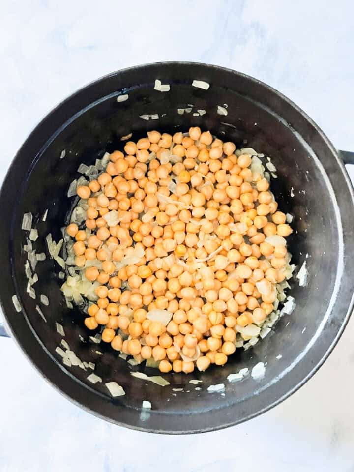 Chickpeas cook in onion and garlic and ginger.