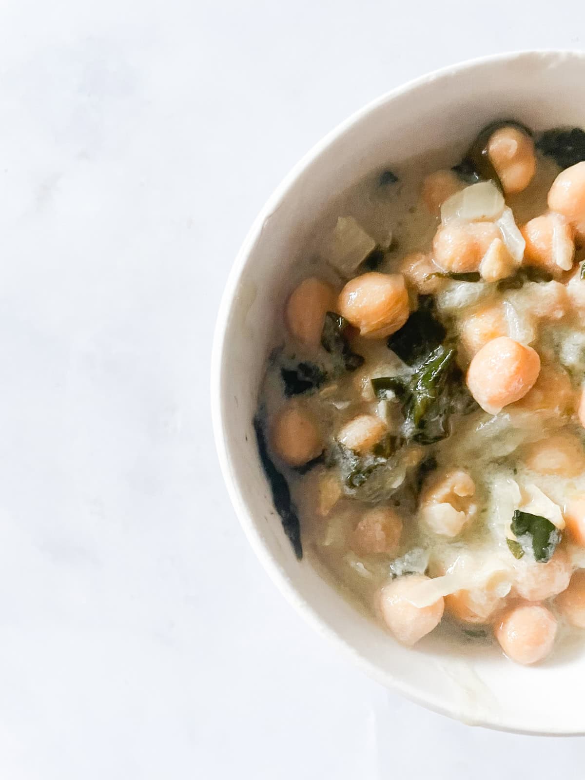 A bowl of coconut milk chickpeas and spinach.