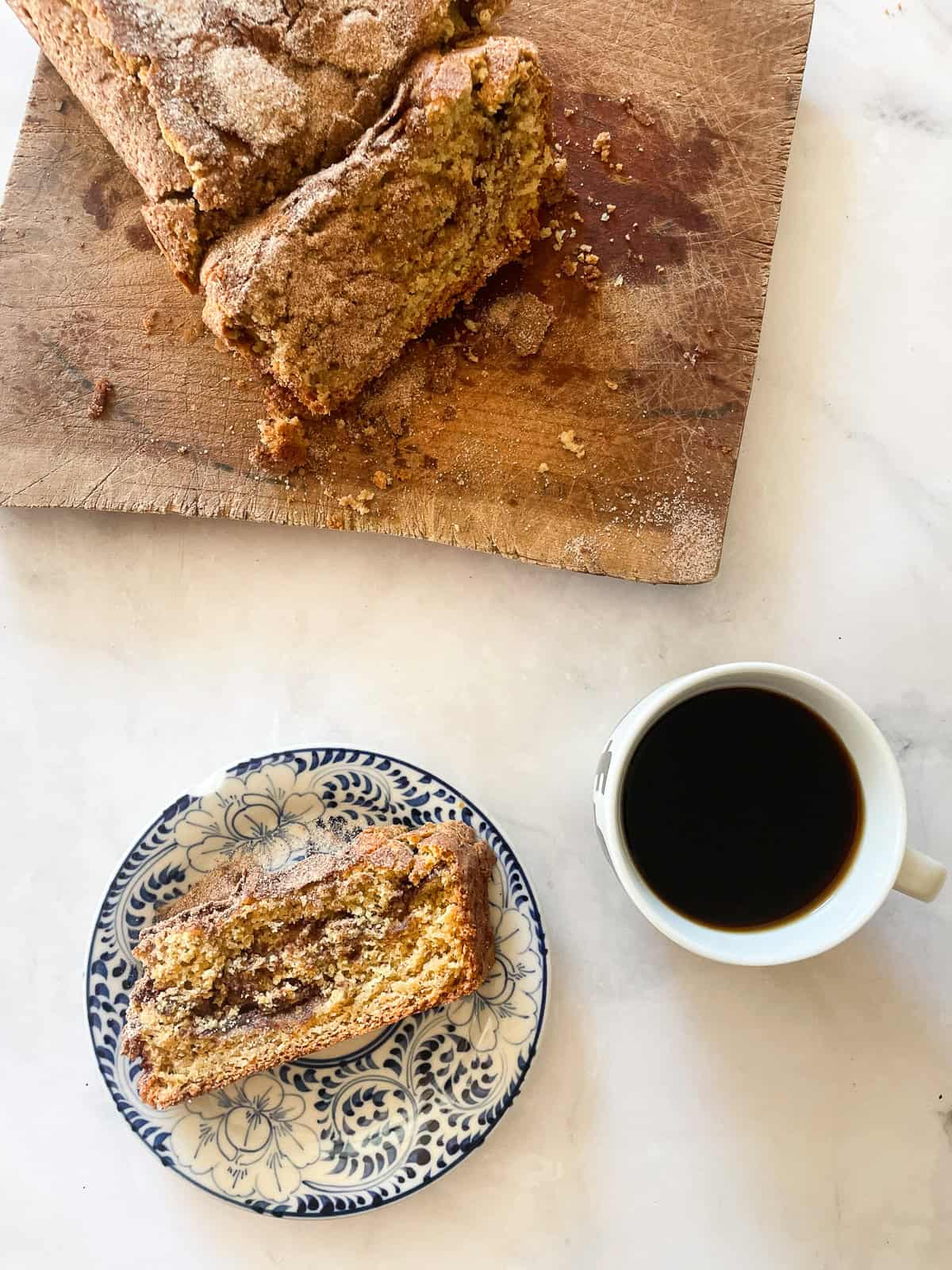 Sliced gluten free cinnamon swirl bread on a cutting board.