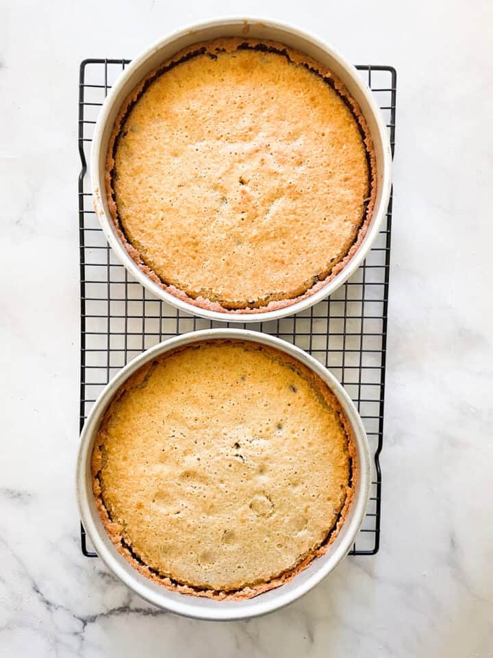 Chocolate chip cake rounds cool in pans on a rack.