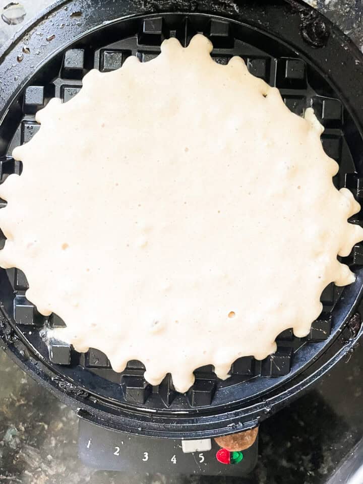 Waffle batter on a waffle iron.