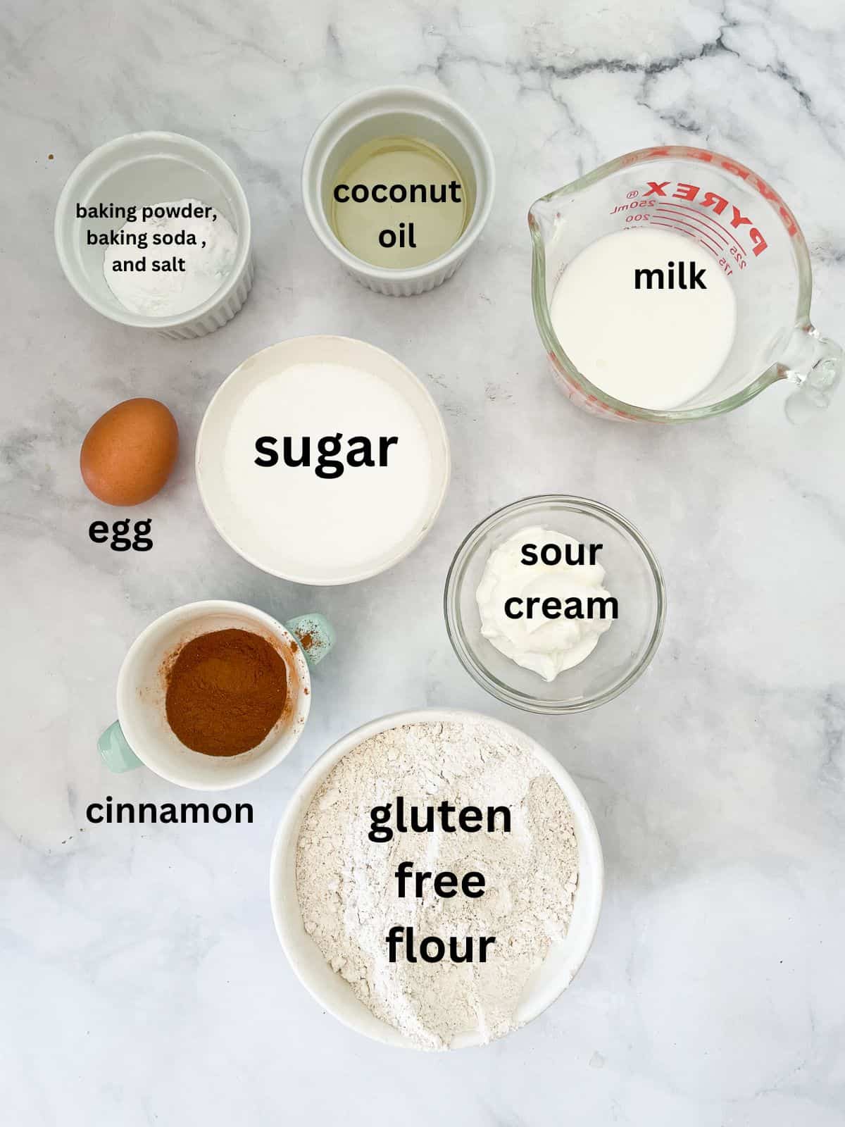 Ingredients for gluten free cinnamon swirl bread are portioned out and text-labeled.