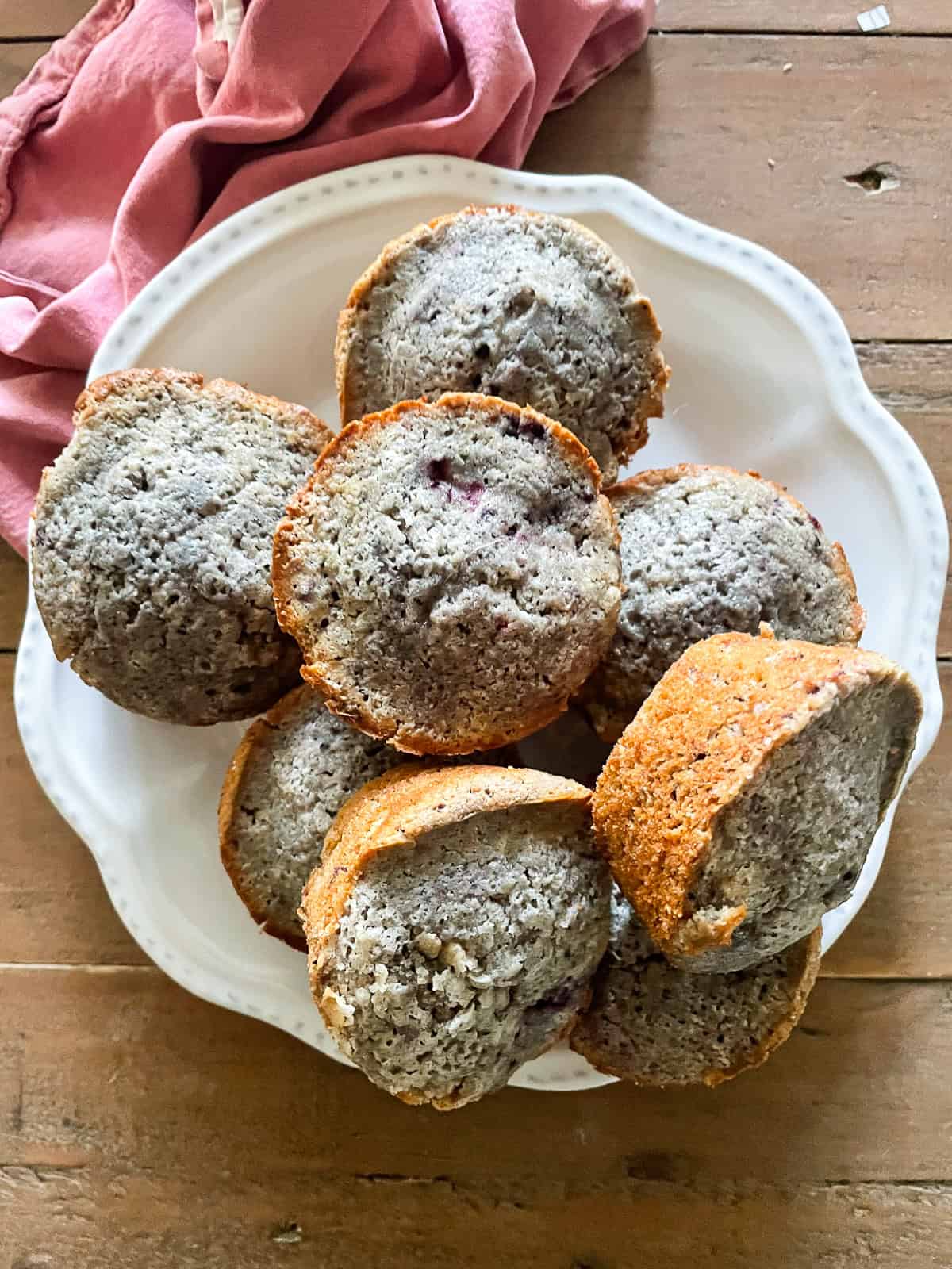 A plate of gluten-free blackberry muffins on a table.