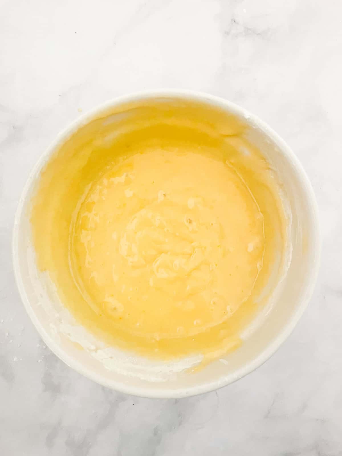 This luscious gluten free blueberry yogurt cake is packed with bright, juicy berries and run through with a brown sugar-cinnamon swirl. Blueberry yogurt cake batter in a bowl.