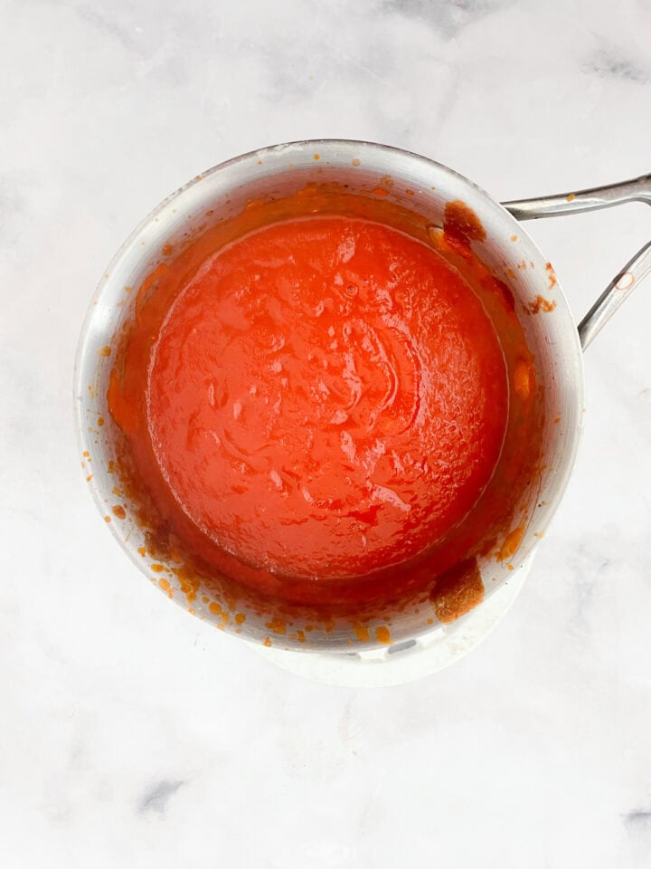 Pureed cream of tomato soup in a pot.