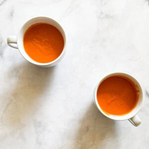 Two cups of vegetarian cream of tomato soup.